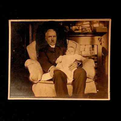 Photograph: John H. Irvine, holding baby (1918)