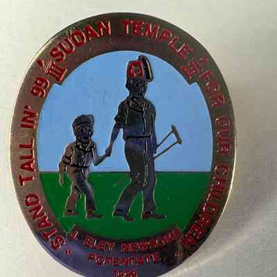 Pin: Shriner. ""Stand Tall in '99/Sudan Temple/For Our Children" Donated by PGM James O. Wood (1999)