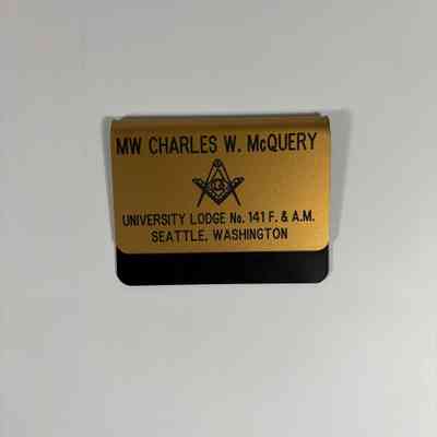 Badge: Past Grand Master Charles W. McQuery. Gold with Black writing. "MW Charles W. McQuery/University Lodge No. 141 F&AM/Seattle, Washington"