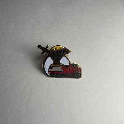Pin: red, gold and white with black lettering. Scimitar, crescent, train. "El Mina/99" Donated by PGM James O. Wood. (1999)