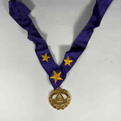 Badge: Past Grand Master's Badge and lanyard. Gold badge, and purple lanyard with gold stars. Donated by PGM James O. Wood (c.2000)
