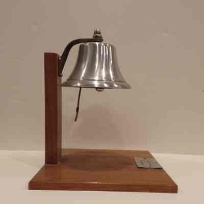 Bell: Attached to wooden stand. Plaque reads "to Exemplar #284 from Queen Anne #242, F&AM 1963"