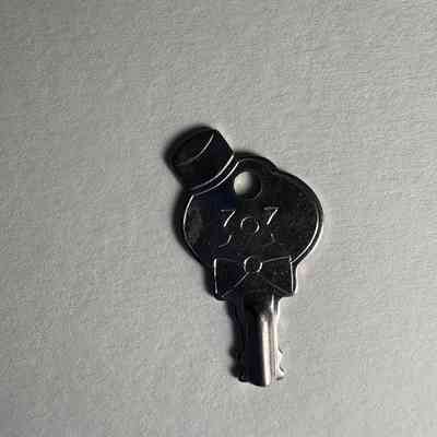 Key: Depicting smiley face with bowtie and hat. James O. Wood's personal symbol. (c. 1999)