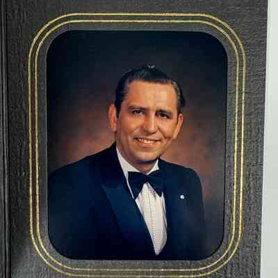 Photograph: In black matting. Of PGM Matt Martin in suit, wearing PGM pin. (c. late 1980s).