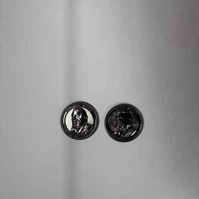 2 Coins: Two Past Grand Master Coins, MW Ed Woods (2022-2023). Depicts Woods bust on the front side, and a puzzle that can be decoded by Masons on the back.