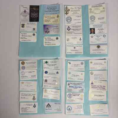 4 Pieces of paper with business cards attached. Various business cards presumably collected by PGM Sam Roberts during his year as Grand Master.