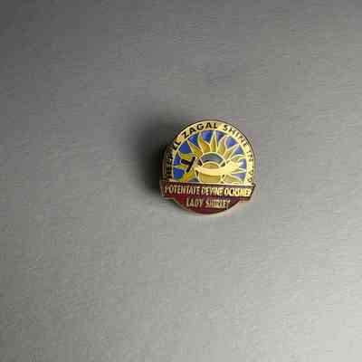 Pin: "Help El Zagal Shrine in '99/Potentate Devine Ochsner Lady Shirley". Donated by PGM James O. Wood (1999)