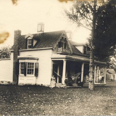 Unknown House with three women on porch