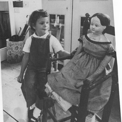 Sally Chisholm in the Museum admiring an 1820 doll
