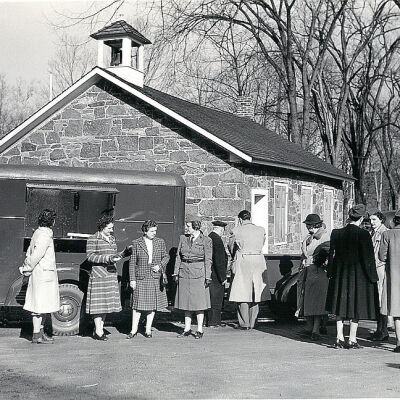 American Red Cross workers outside of the School House