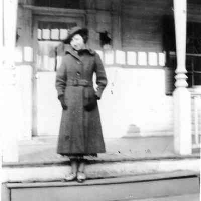 Unidentified woman by door to Bedford residence