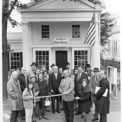 Opening of the remodeled Post Officefeatures a group gathered outside for a ribbon-cutting ceremony.