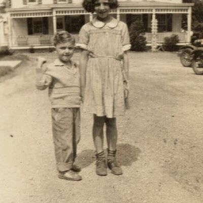Gerri Glasser and brother in front of Glasser home