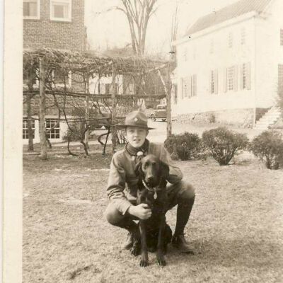 Bob Glasser with the family dog, behind the Empire Building