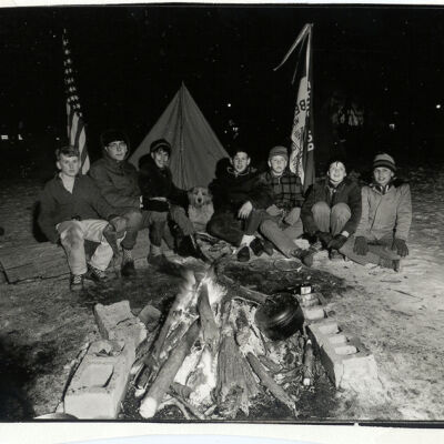 Boy Scouts around campfire on Village Green (troop 129)