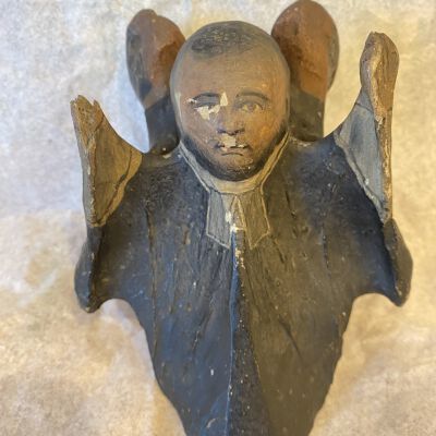 wooden figure of reverend or priest
