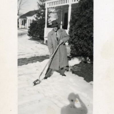 Mr. Glasser shoveling snow