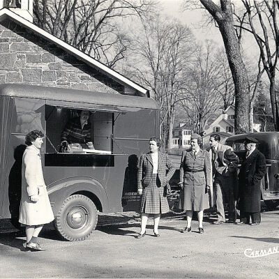American Red Cross workers outside of the School House