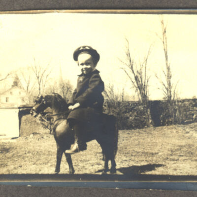 unidentified child on toy horse