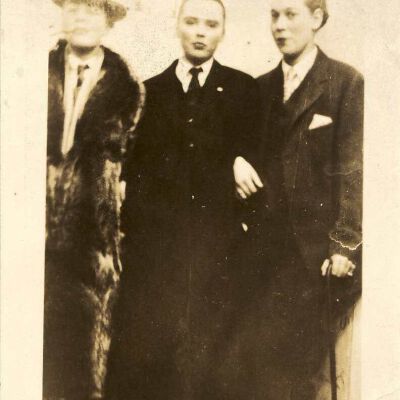 Three unknown women dressed as men