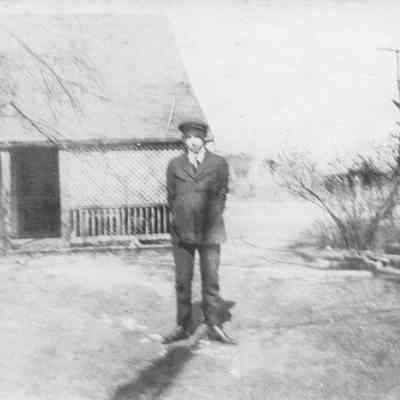 "A friend" in backyard, ca 1920 (?)