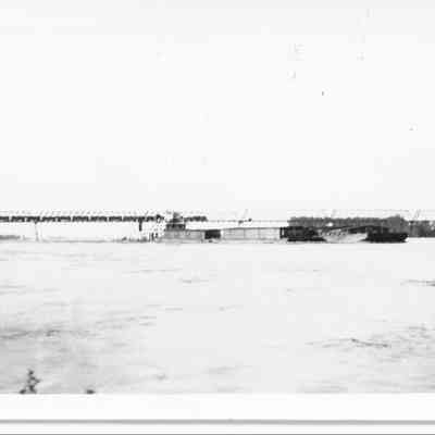 "The 'Franklin Roosevelt' with a tow passing under the railroad bridge - Flood June 1935