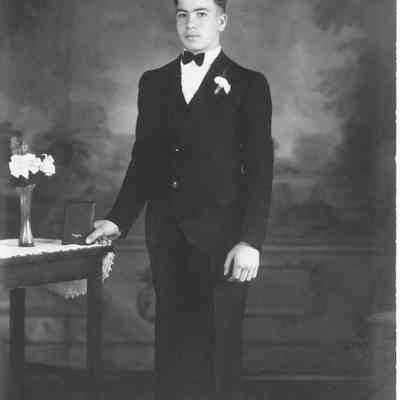 "My Confirmation" photo of young man in dark suit, flower in lapel, 1910