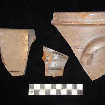 Coarse Earthenware/stoneware pot with handle and alkaline-type glaze.