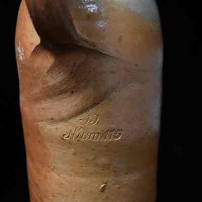 B NUM:115 embossed on back, beneath handle.