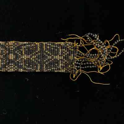 Detailed image of black and gold Native American Spirt belt with beaded pattern.