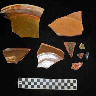 Fragments of lead-glazed, coarse earthenware vessels, including milk pans.