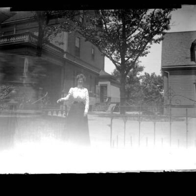 Lady at gate (unknown location)