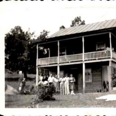 Riddleburgh home on Norton Road with family outside