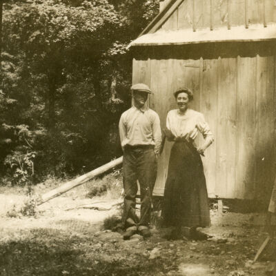 A man and woman standing outside a building, Clermont