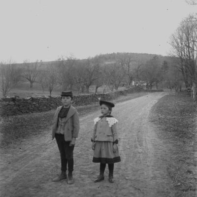 Roscoe & Marion Teator standing in a road by the orchard