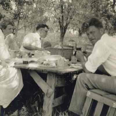 Mead family picnic, seated on apple crates, July 4, 1924