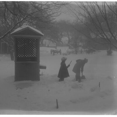 Marion & Roscoe Teator next to well house in snow