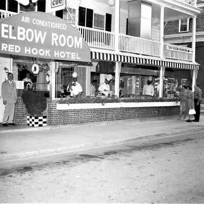 Red Hook Hotel with chefs in front windows, 1960