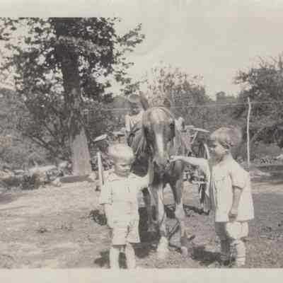 Three children and a horse and wagon