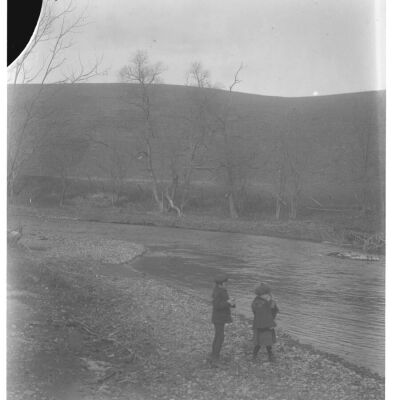 Roscoe & Marion Teator tossing pebbles into stream
