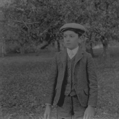 Roscoe Teator standing in orchard