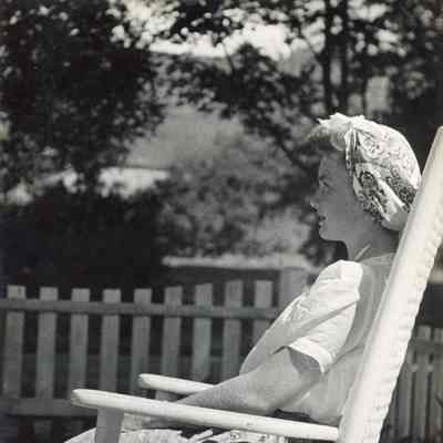 Beth Mead as a young woman, seated on porch