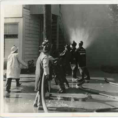 Red Hook Fire Department firemen hosing down building