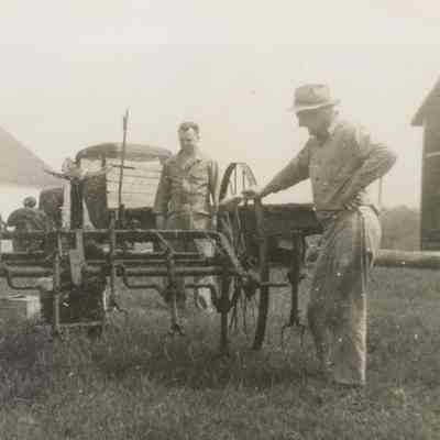 William Redder and another man looking at farm equipment