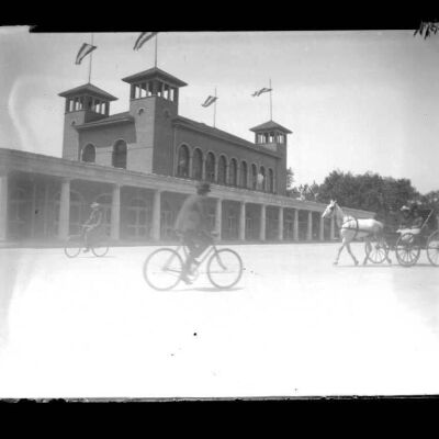 Exposition building and cyclists (Location unknown)
