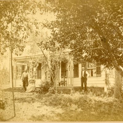 Minkler family in front of their farmhouse