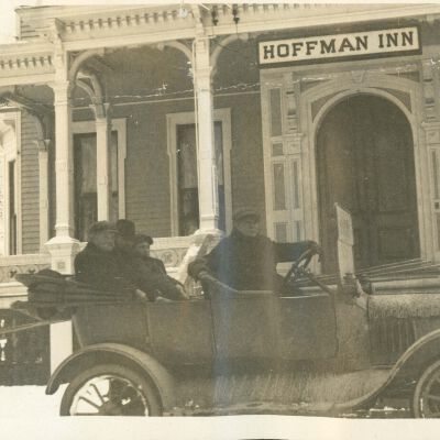 Car in front of Hoffman Inn Horace and friend