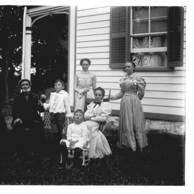 Nena Teator with Myers family next to W. S. Teator house