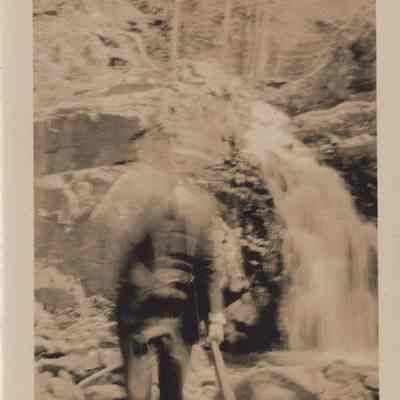 Photo of man and waterfall
