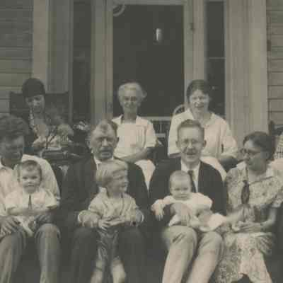Mead family seated on front porch, c. 1925